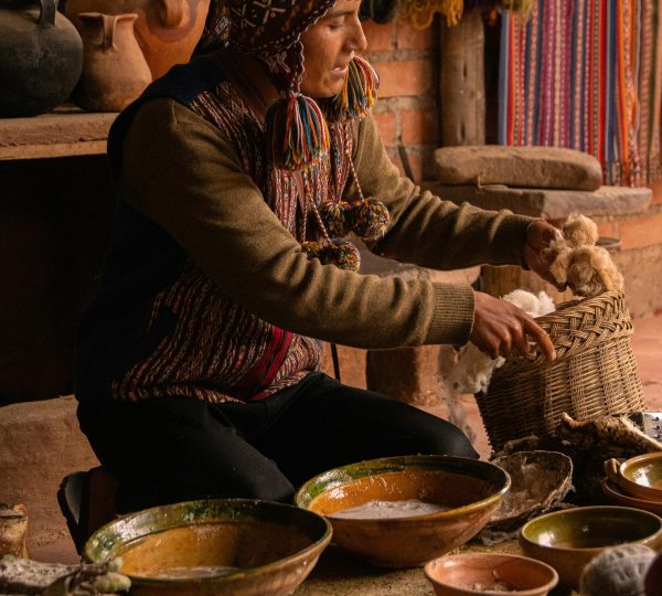 Peru Markets. Man in Traditional Clothing Sitting with Basket and Bowls