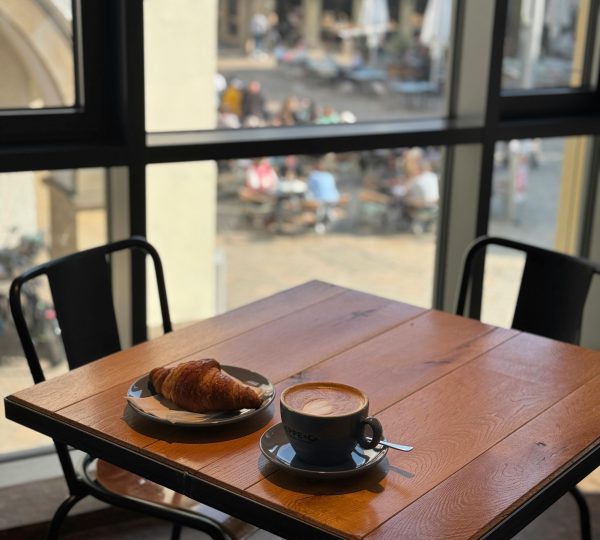 Cozy Cafe Table with Croissant and Coffee